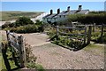 TV5197 : An old cattle grid and Coastguard Cottages by Philip Halling