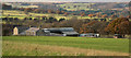 Field descending towards farm at Spring Well