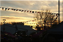 TQ2481 : View of flags against the setting sun from the Portobello Road Winter Festival #5 by Robert Lamb