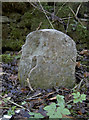 Battered boundary stone