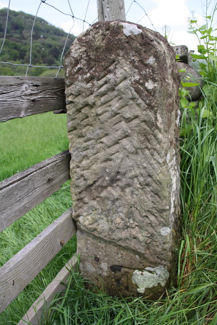 Benchmark on gatepost beside A6108 at Thorpe Under Stone