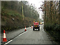 A convoy vehicle leads traffic through works on the B3230