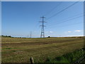 The North-South Interconnector crossing a harvested hay field north of Coiners Lane