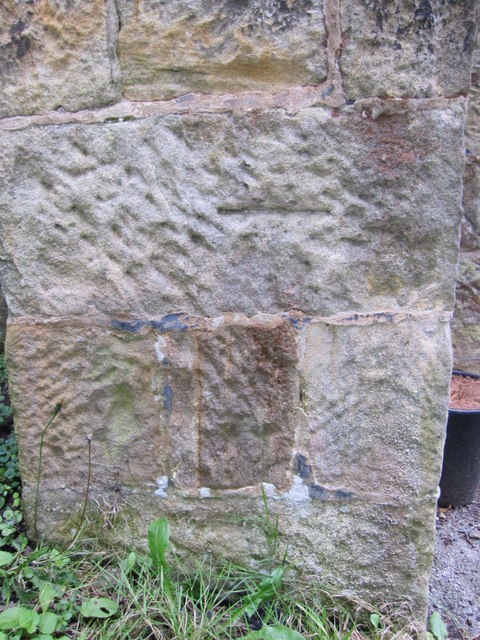 Weathered bench mark on St Margaret's, High Bentham