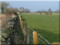 NY6422 : Fence replacing wall, along a road called South End by Christine Johnstone