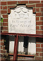 Gravestone in brick wall