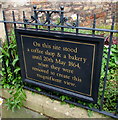 Sadler Street board recording the site of demolished coffee shop & bakery, Wells