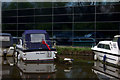 Boats and reflections in modern glass building