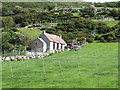 Tin roofed traditional cottage on the lower slopes of Slievegarran