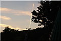 View of a vapour trail looking as if it is coming out of the chimney of a house on Marine Parade