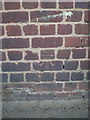 SP0387 : OS benchmark - Smethwick, Grove St factory wall by Richard Law
