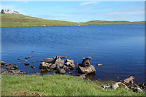 HU5562 : Rocks and Old Iron, Loch of Huxter by Des Blenkinsopp