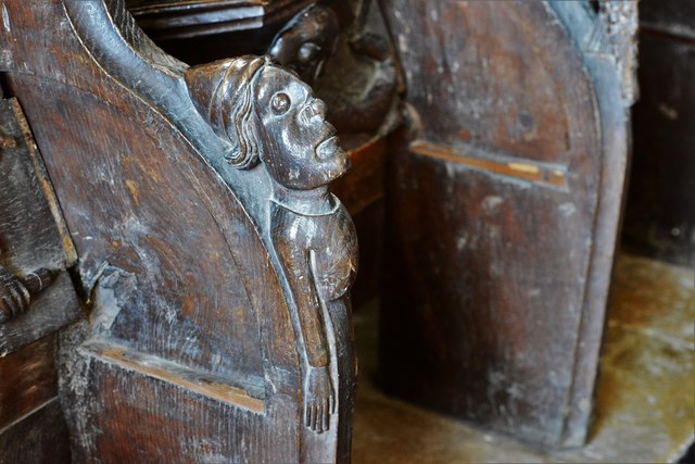 Swinbrook, St. Mary's Church: Carvings on the armrests of the medieval choir stalls 1