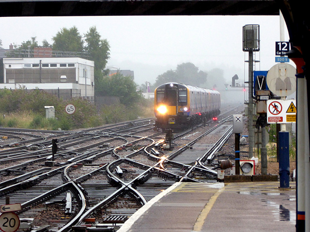 A train approaching Eastleigh station in pouring rain