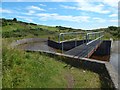 NS2774 : Whinhill Reservoir: footbridge over outflow by Lairich Rig