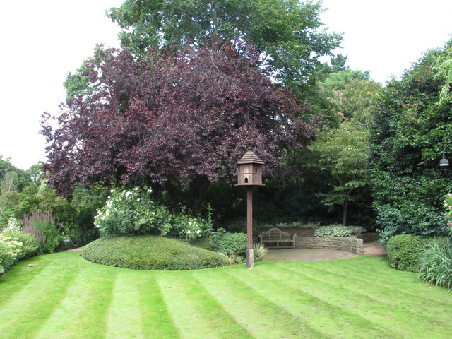 The Holme, wooden dove house on pole in lawn