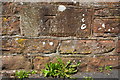 Benchmark on stone in Beacon Edge wall