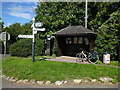 Bus shelter, phone box, rubbish bin and signpost at Edington