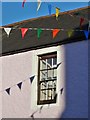 Window with bunting and shadows