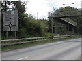 Grimy directions sign near an A467 footbridge, Brynmawr