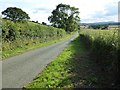 Country road descending to the A458