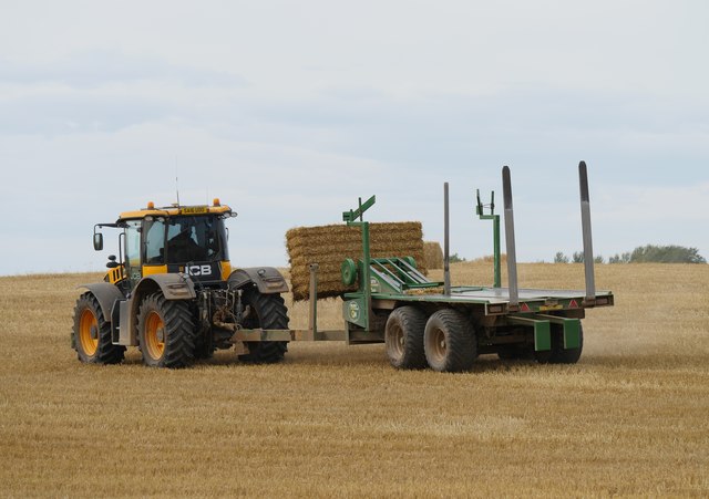 Clearing a field of bales