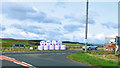 NY8791 : Smiley Bales at the Junction by Des Blenkinsopp