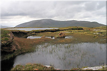 NC3361 : Water and peat banks at summit of Ghlas-bheinn by Trevor Littlewood