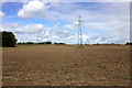 Powerlines across a ploughed field