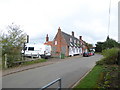 Carbrooke: houses opposite the church