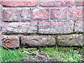 Weathered bench mark on New Road Farm barn