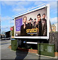 Two telecoms cabinets and an advertising board on a city centre corner, Newport