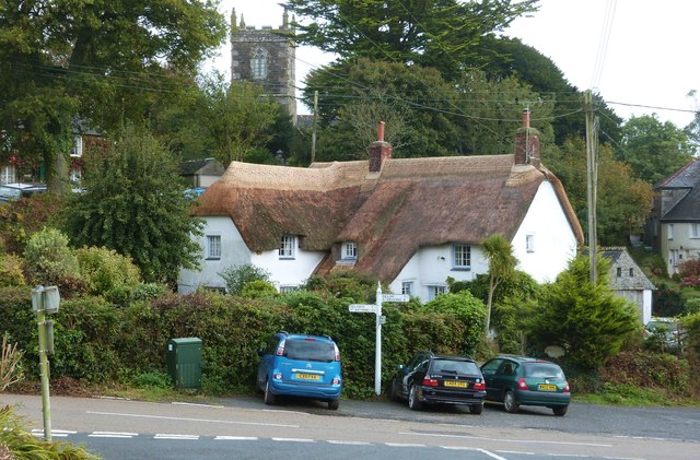 Lovely thatched house with the tower of the parish church of St Manaccus showing through the trees