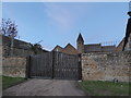 Barford St John Church: church glimpsed beyond a yard