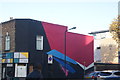 View of abstract street art on the side of Landlords Furniture + Appliances from Wood Street