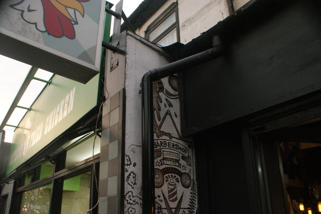 View of street art on the side of Hair from the Heart hair salon on Hoe Street #3