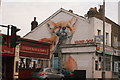 View of fox street art on the side of the New Dragon Inn Chinese takeaway on Hoe Street