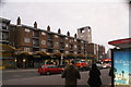 View of a parade of shops with a wavy balcony on Hoe Street