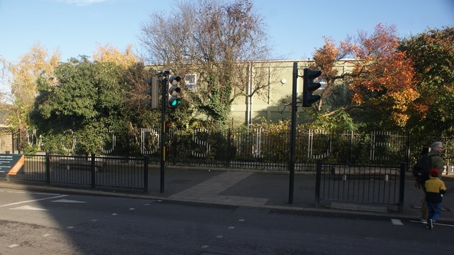View of "WOODSIDE" painted on the railings of The Woodside School from Wood Street
