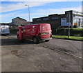 Queen Elizabeth II pillarbox and a Royal Mail van on a Bettws corner