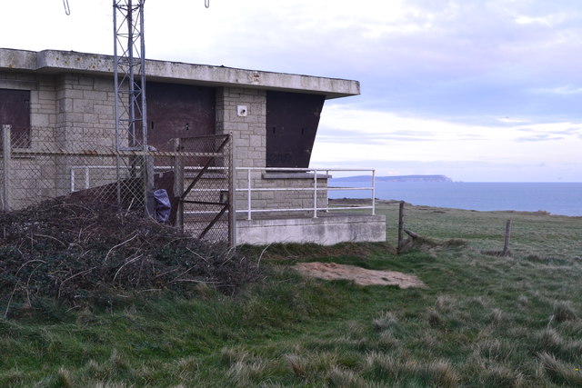 Disused Coastguard station on Hengistbury Head, with The Needles beyond