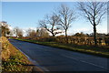 TM4259 : Looking east up the A1094 at the drive to Park Farm by Christopher Hilton