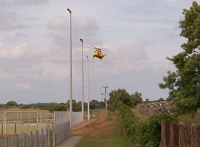 A helicopter of 22 Sqn RAF Valley transporting a casualty to Ysbyty Gwynedd