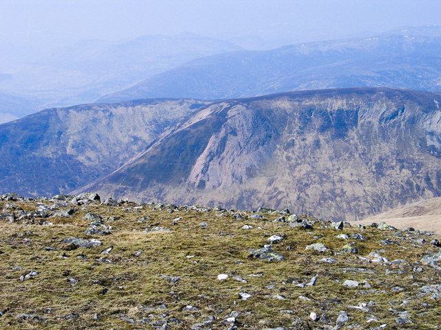 Grassed ground with studded rocks at summit of Carn Gorm