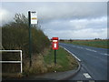 TA2145 : Elizabeth II postbox and bus stop on the B1242, Rolston by JThomas