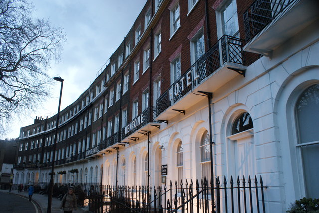 View of the Mentone Hotel on Cartwright Gardens illuminated at dusk
