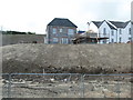 Detached and semi-detached houses under construction and Peggy