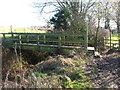 Sturdy footbridge over a deep drainage ditch