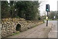 SK9843 : Stone wall with underpass, B6403 in Ancaster by Chris