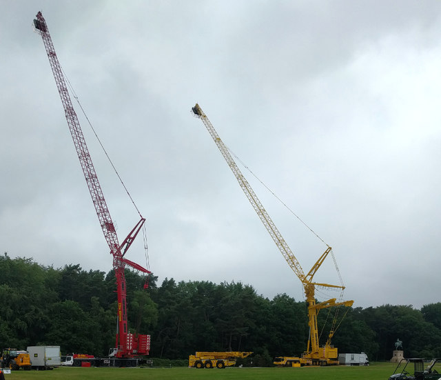 Cranes carrying lighting gantries for filming